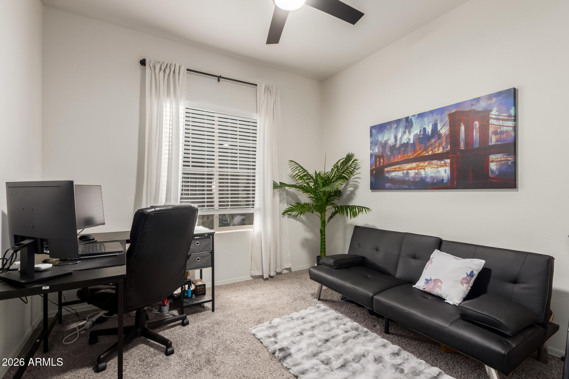 11214 West Bloch Road Tolleson, AZ 85353 - Photo 18 of 24 a view of a livingroom with workspace and a couch