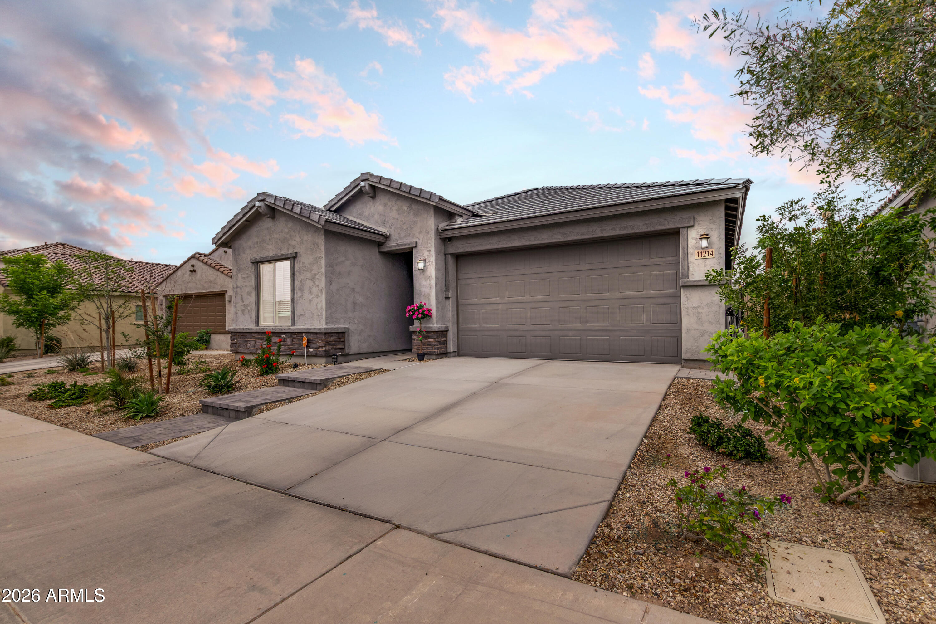 11214 West Bloch Road Tolleson, AZ 85353 - Photo 2 of 24 a front view of a house with a yard and garage
