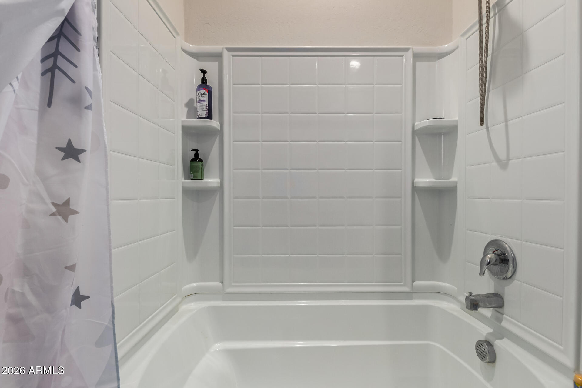 11214 West Bloch Road Tolleson, AZ 85353 - Photo 21 of 24 a bathroom with a shower and a bath tub