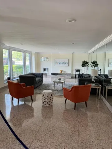 a living room with furniture kitchen and a table