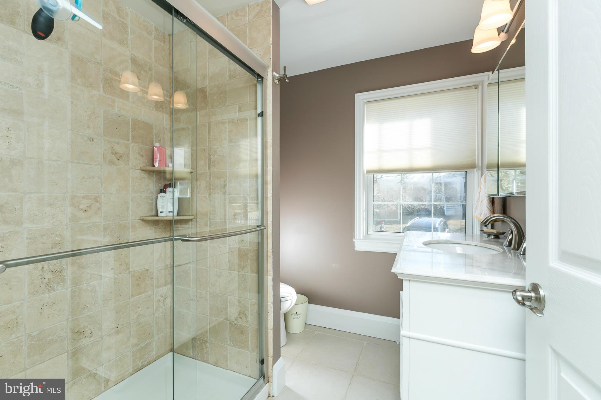611 Wilton Road Towson, MD 21286 - Photo 18 of 30 a bathroom with a sink toilet and shower