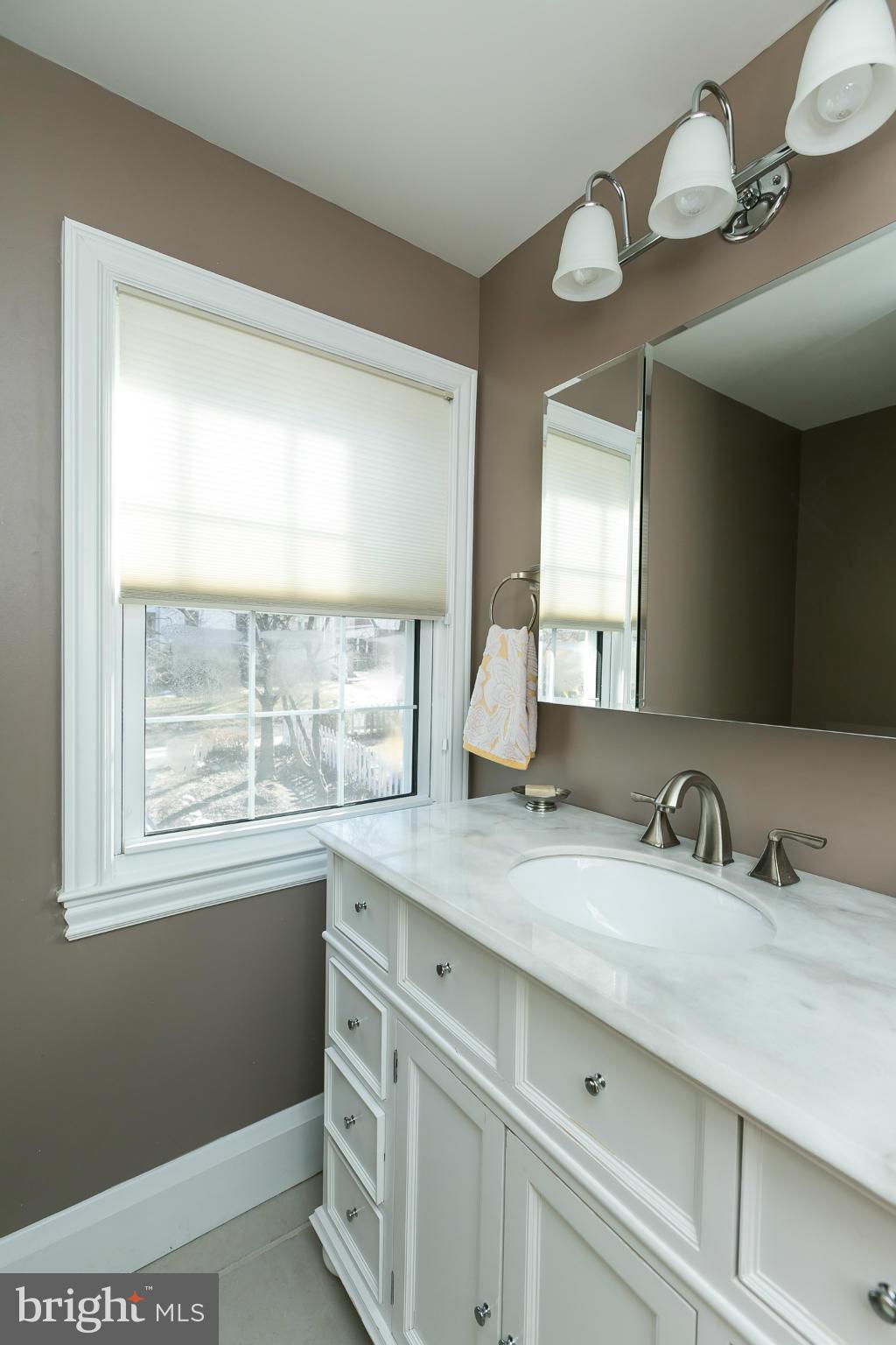 611 Wilton Road Towson, MD 21286 - Photo 19 of 30 a bathroom with a sink a vanity and a large mirror