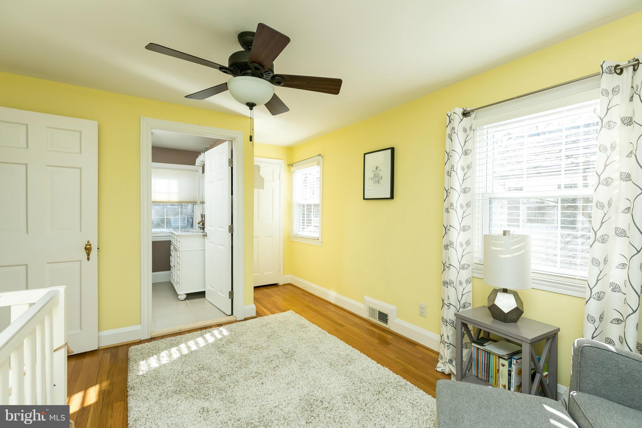 611 Wilton Road Towson, MD 21286 - Photo 22 of 30 a bedroom with a bed and a chandelier