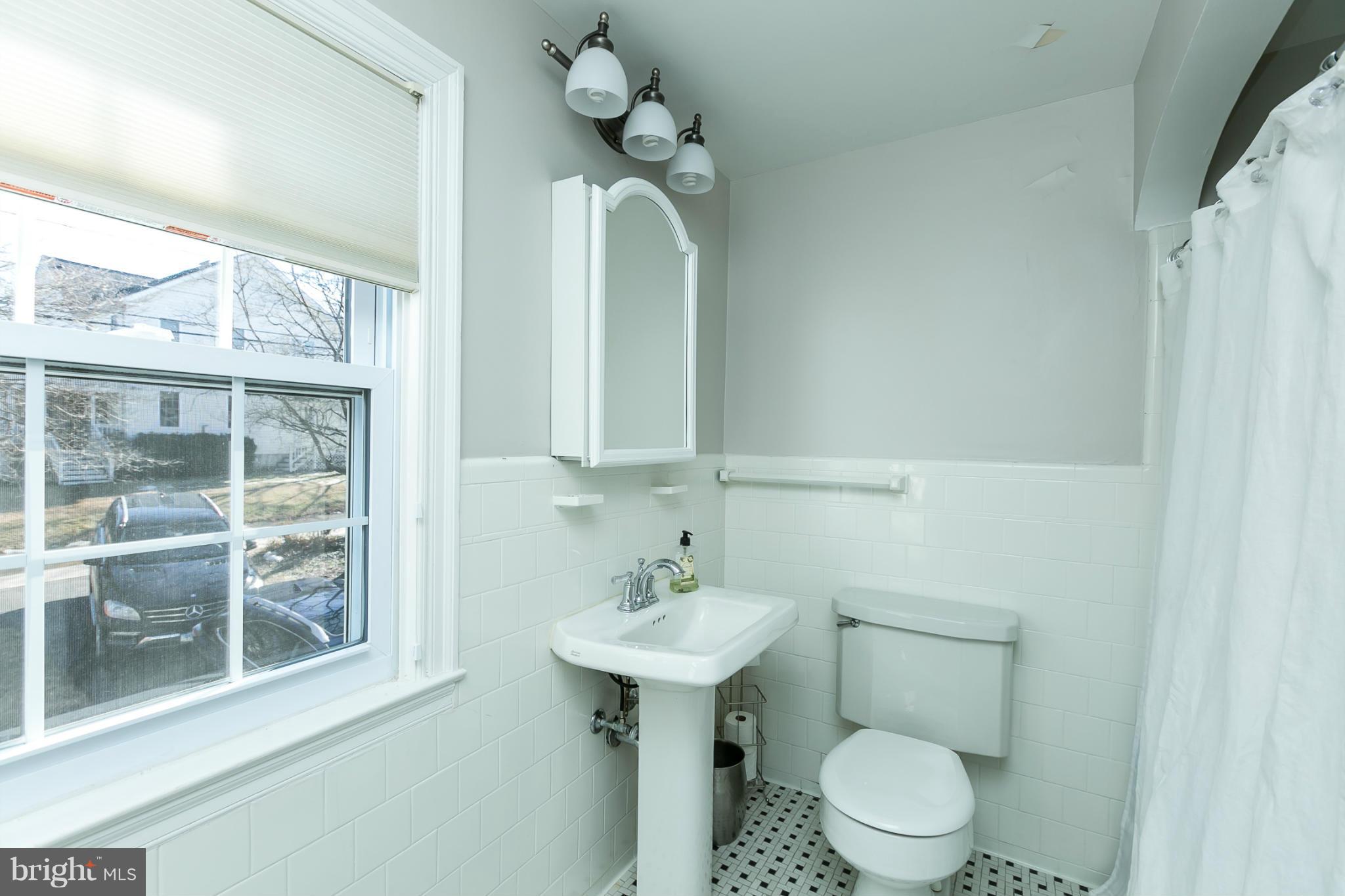 611 Wilton Road Towson, MD 21286 - Photo 24 of 30 a bathroom with a toilet a sink and mirror