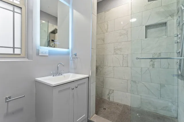 a bathroom with a sink a toilet and a mirror