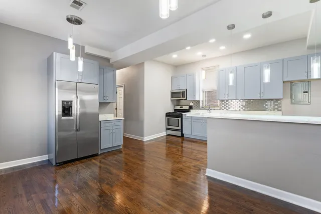 a kitchen with a refrigerator and a sink