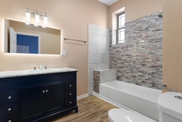 a bathroom with a sink a toilet and bathtub