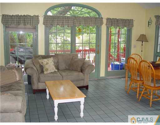 23 Phillips Road Edison, NJ 08817 - Photo 4 of 12 a living room with furniture and a floor to ceiling window