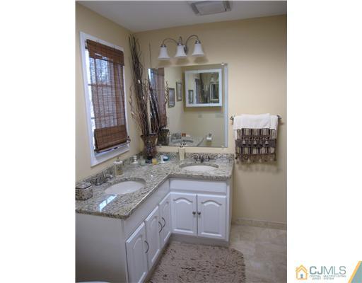 23 Phillips Road Edison, NJ 08817 - Photo 8 of 12 a bathroom with a granite countertop sink and a mirror