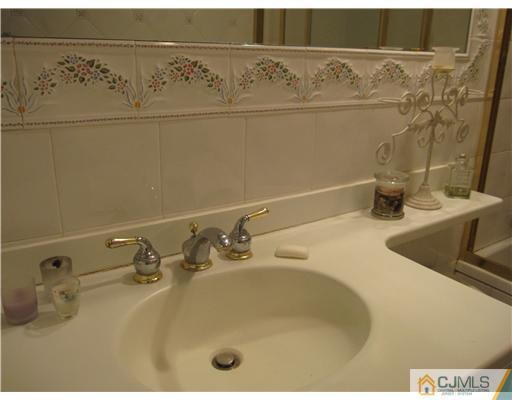 23 Phillips Road Edison, NJ 08817 - Photo 9 of 12 a bathroom with a sink and a mirror