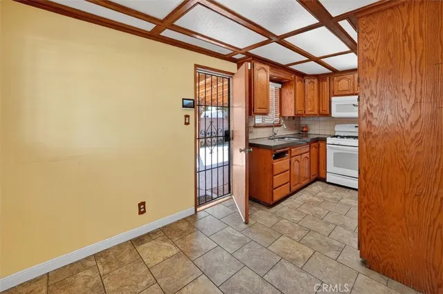 a kitchen with stainless steel appliances granite countertop a stove and a refrigerator
