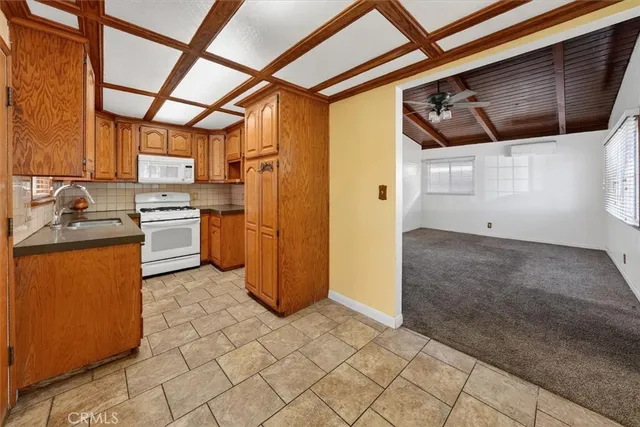 a kitchen with stainless steel appliances granite countertop a refrigerator and a stove