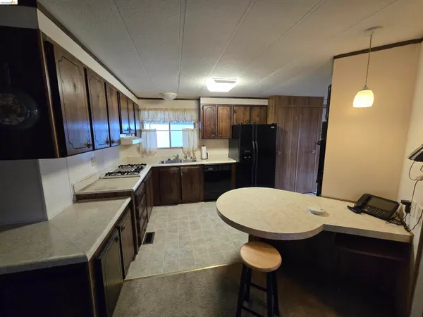 a kitchen with a table chairs sink and cabinets