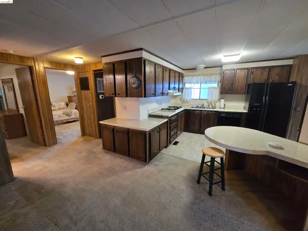 a large kitchen with a table and chairs