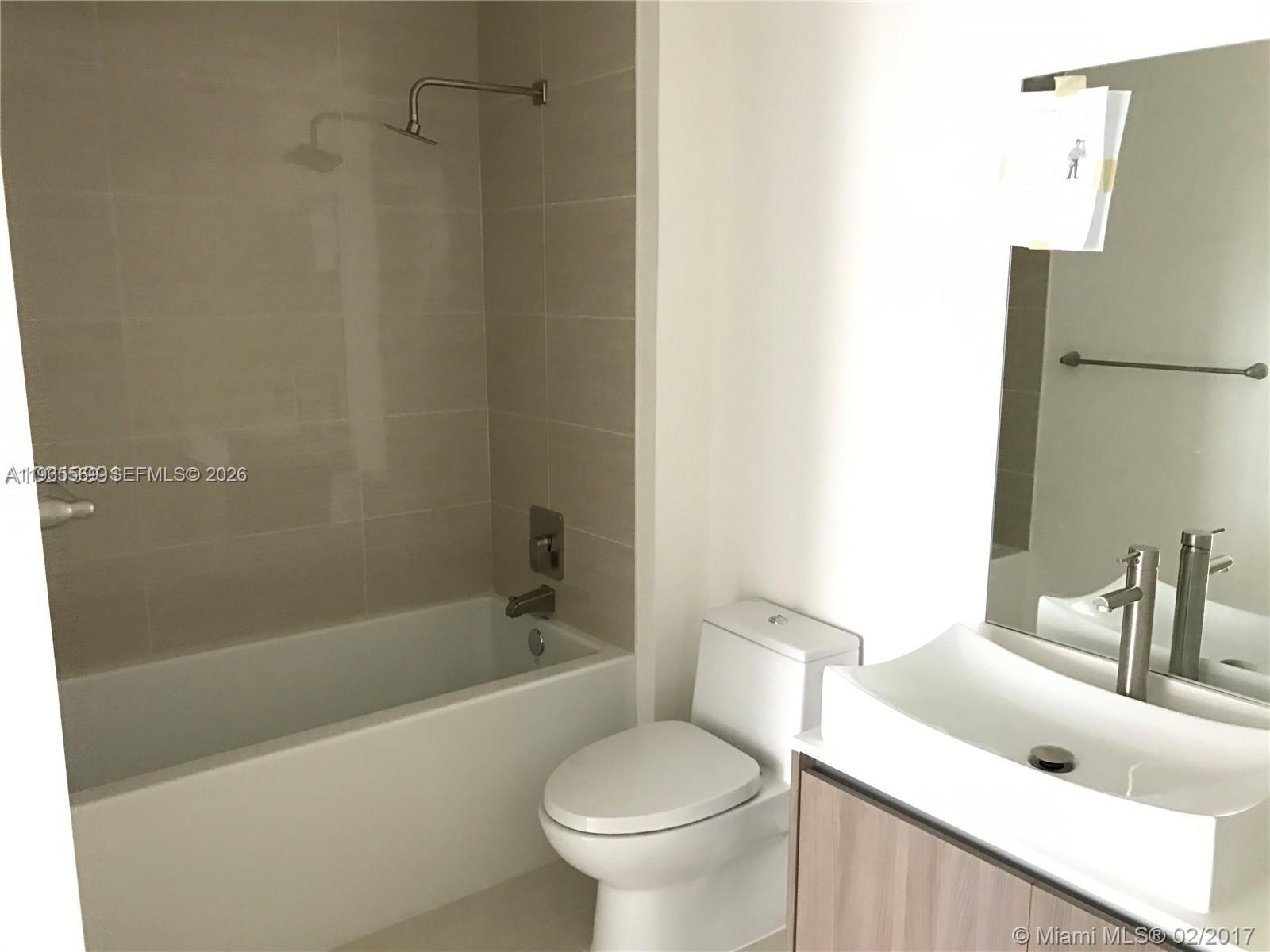 201 Southwest 17th Road, Unit 504 Miami, FL 33129 - Photo 6 of 9 a bathroom with a sink a toilet and a bathtub