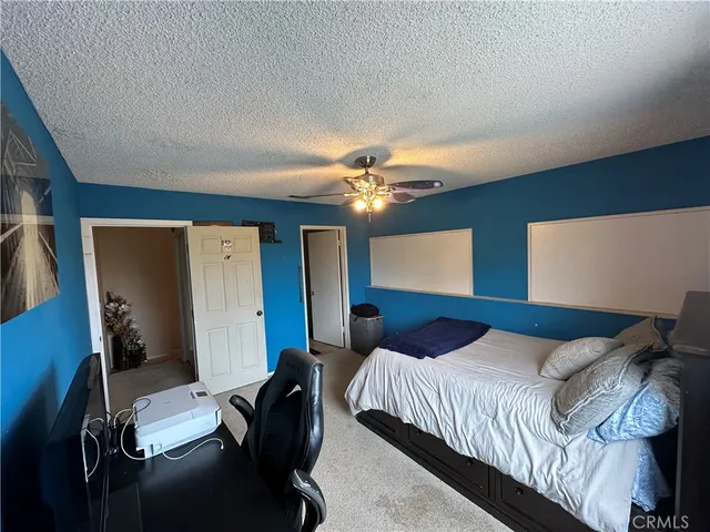 a kitchen with a stove a refrigerator and a dining table with wooden floor