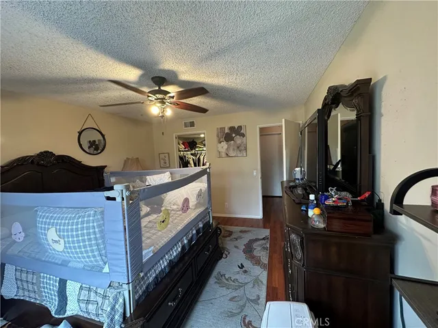 a bedroom with a bed and flat screen tv