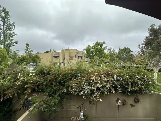 a view of a roof deck with table and chairs under an umbrella