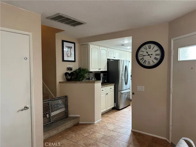 a kitchen with refrigerator and cabinets