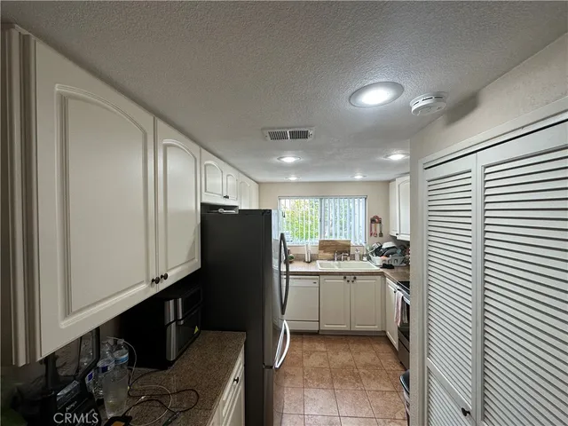 a kitchen with a stove and white cabinets