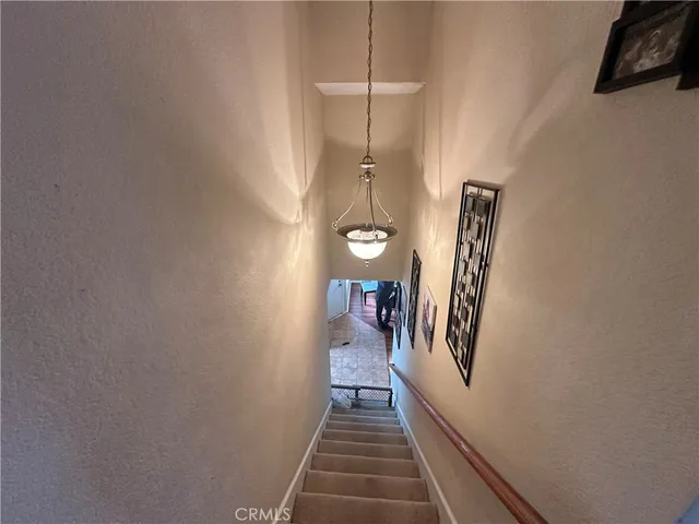 a spacious bedroom with a bed and a chandelier