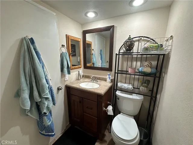 a bathroom with a toilet a sink and mirror