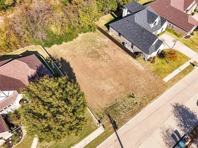 a view of a backyard with wooden fence