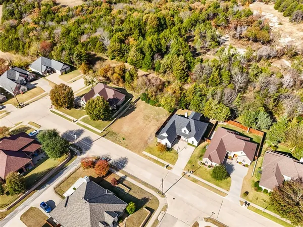 an aerial view of residential building and lake