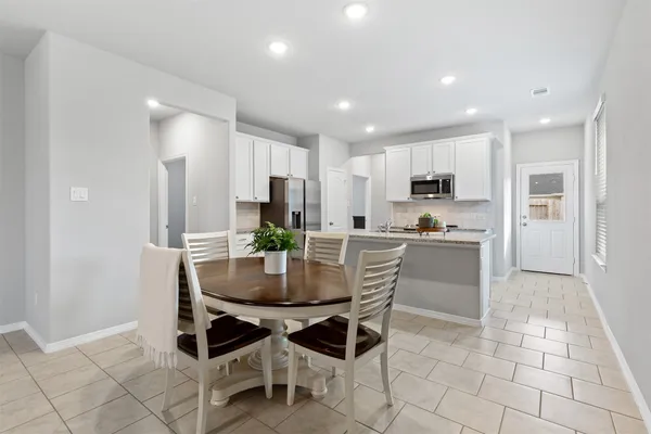 a kitchen with stainless steel appliances granite countertop a refrigerator a stove and a sink