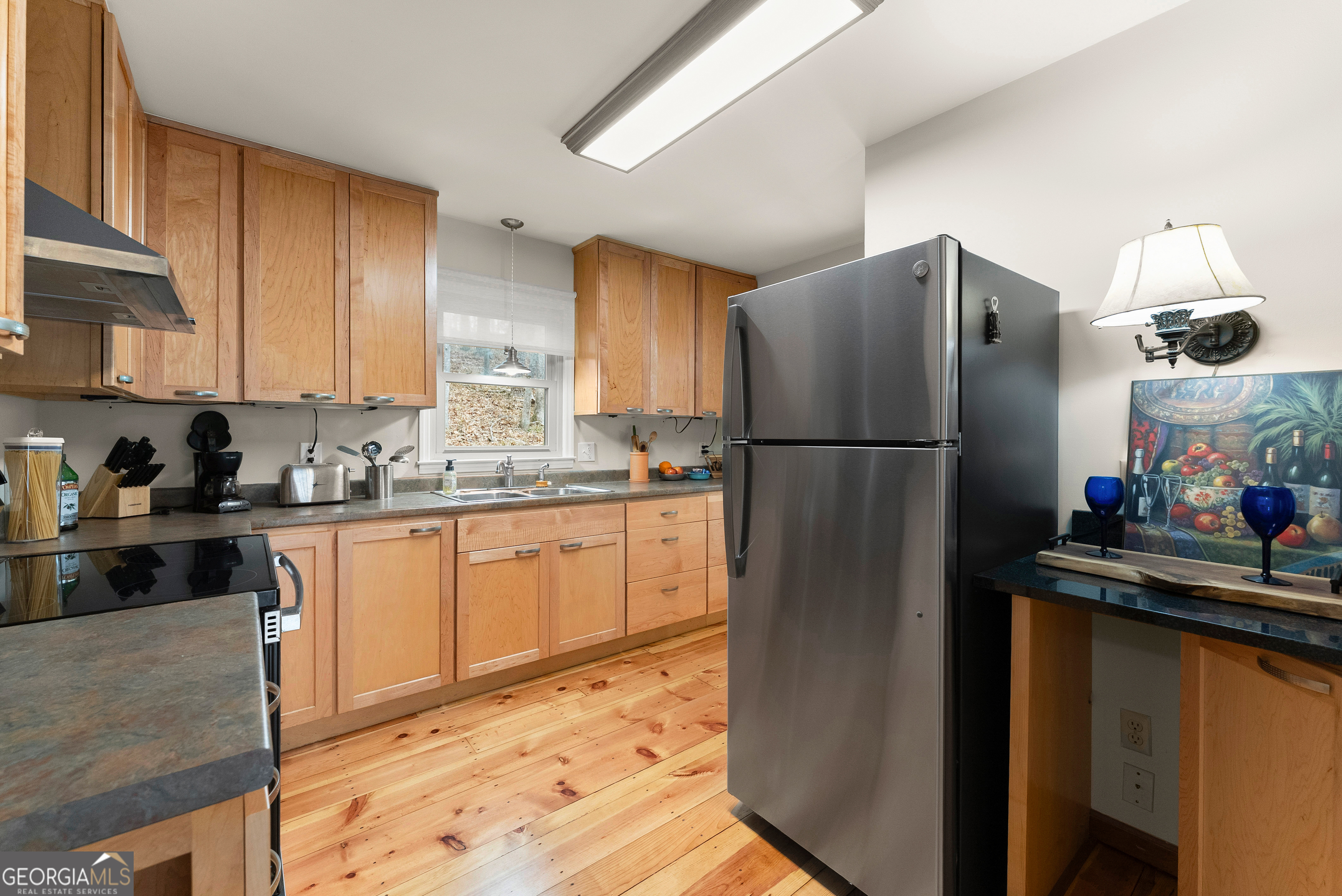 426 Skyview Circle Clarkesville, GA 30523 - Photo 11 of 42 a kitchen with stainless steel appliances granite countertop a refrigerator and a sink