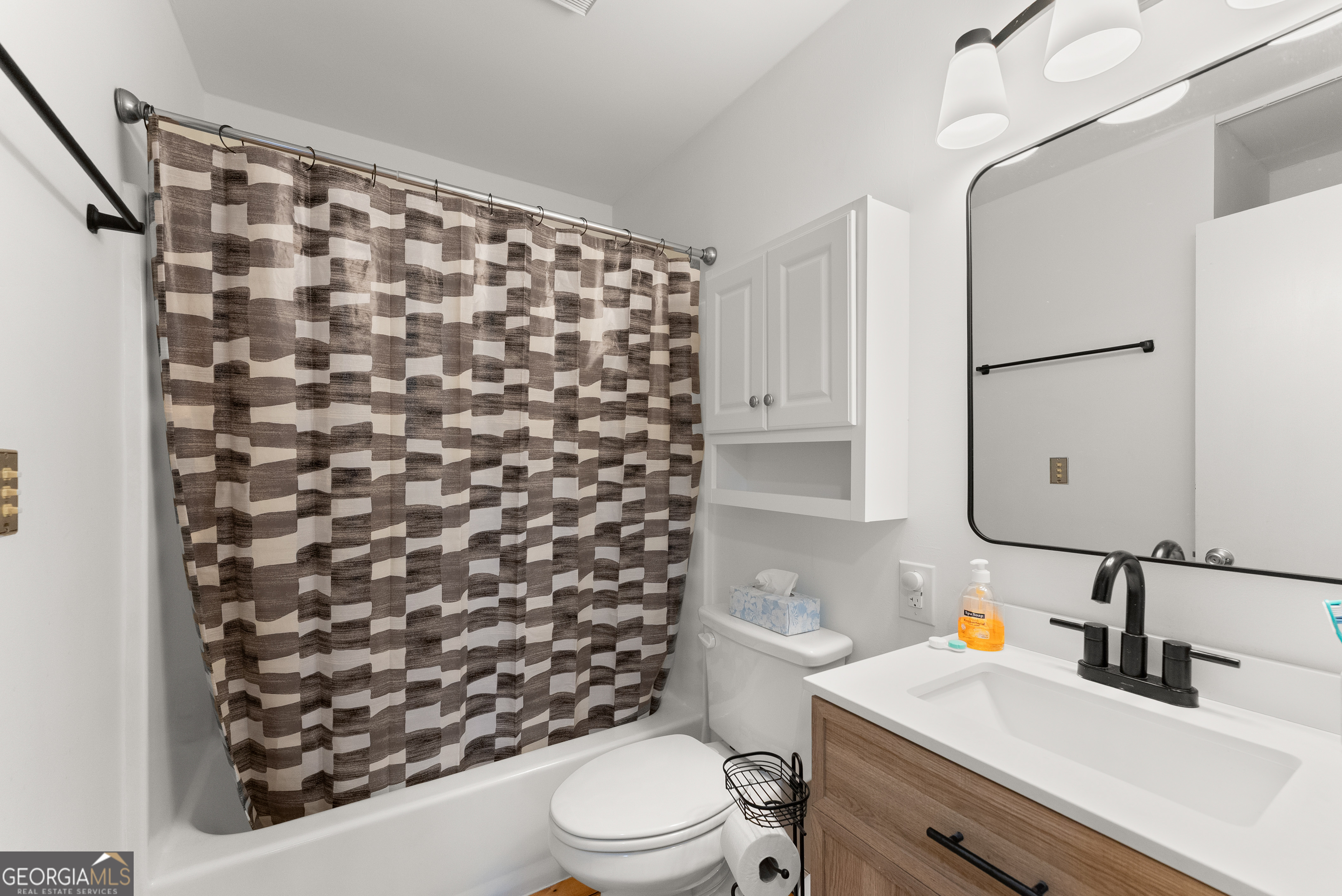 426 Skyview Circle Clarkesville, GA 30523 - Photo 17 of 42 a bathroom with a sink toilet vanity and shower