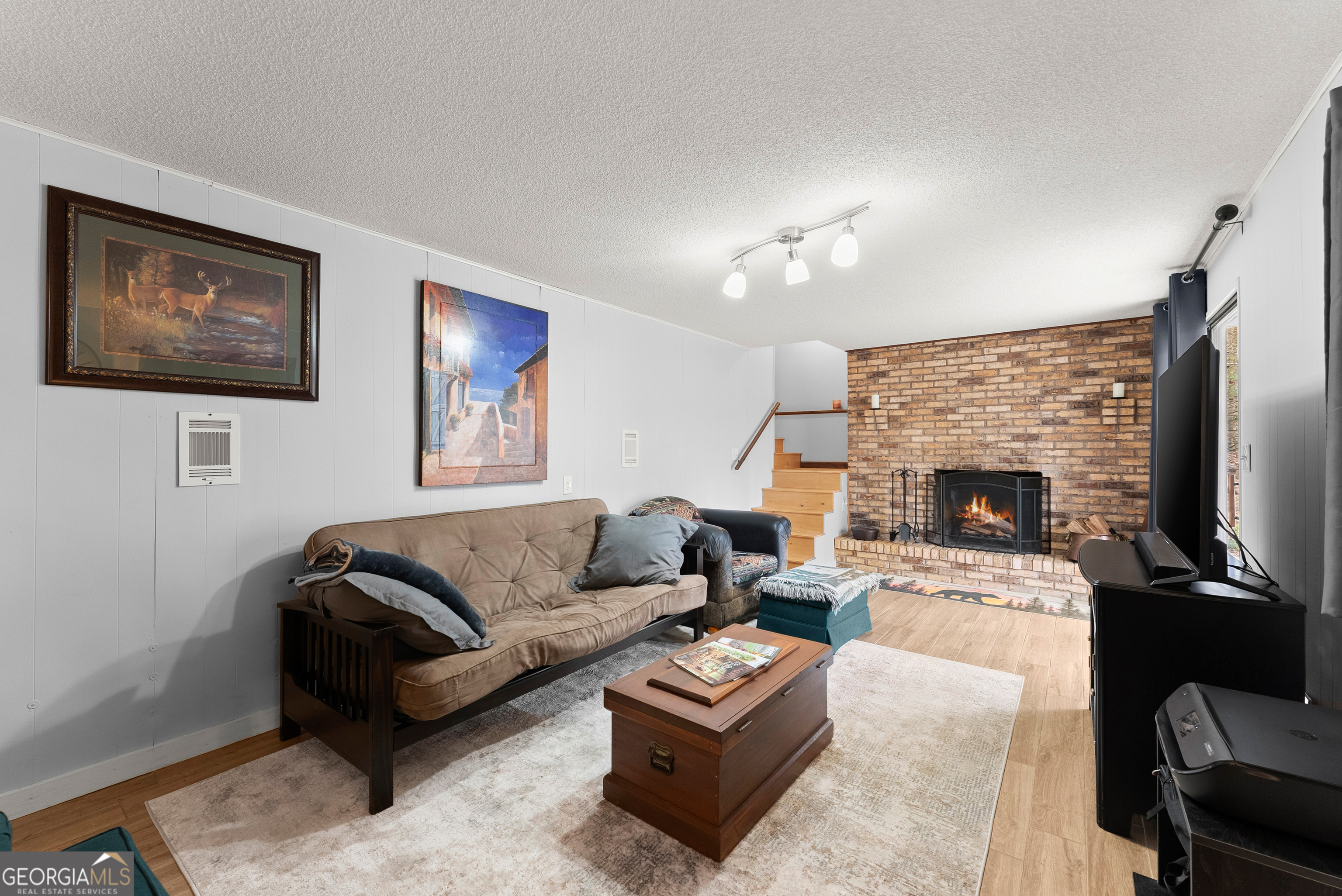 426 Skyview Circle Clarkesville, GA 30523 - Photo 21 of 42 a living room with furniture a flat screen tv and a fireplace