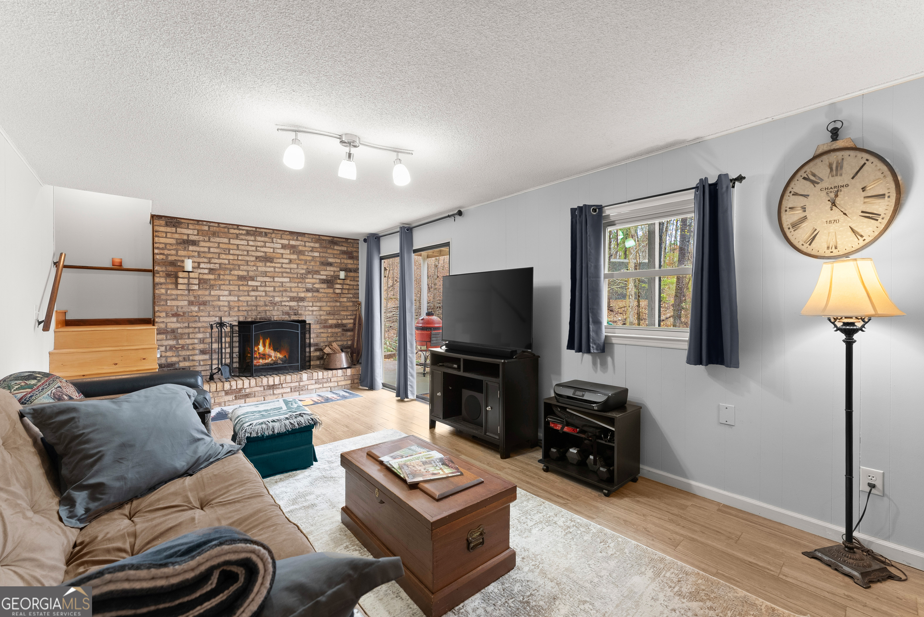 426 Skyview Circle Clarkesville, GA 30523 - Photo 22 of 42 a living room with furniture a fireplace and a flat screen tv