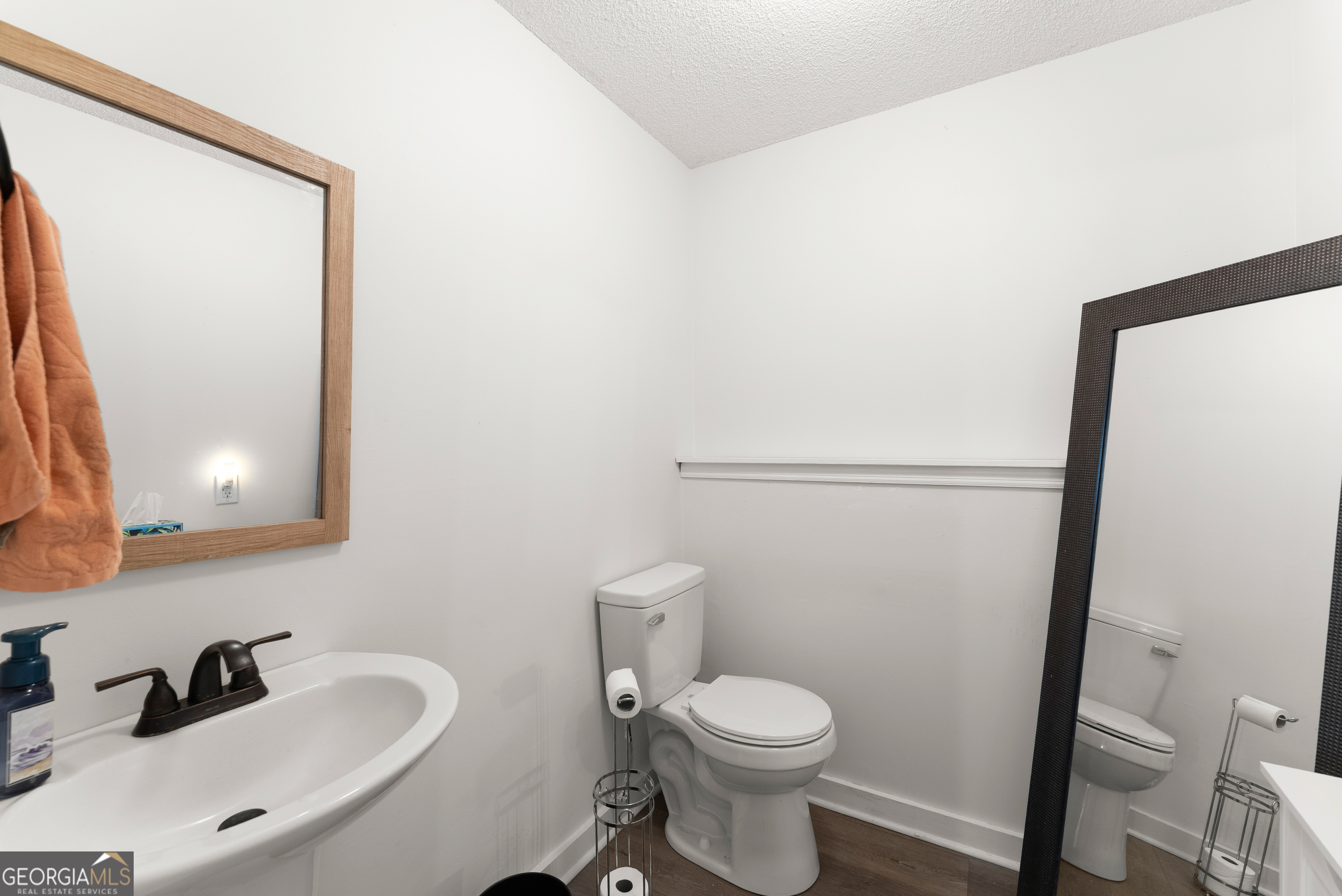 426 Skyview Circle Clarkesville, GA 30523 - Photo 24 of 42 a bathroom with a toilet a sink and a mirror