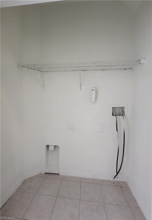 14708 Sutherland Avenue Naples, FL 34119 - Photo 20 of 24 Laundry room with hookup for a washing machine and light tile patterned floors