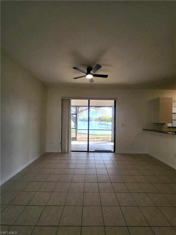 14708 Sutherland Avenue Naples, FL 34119 - Photo 3 of 24 Unfurnished room with a ceiling fan and light tile patterned floors