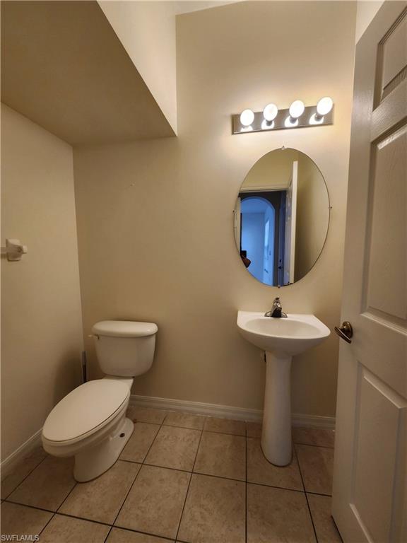 14708 Sutherland Avenue Naples, FL 34119 - Photo 4 of 24 Bathroom with toilet and light tile patterned floors
