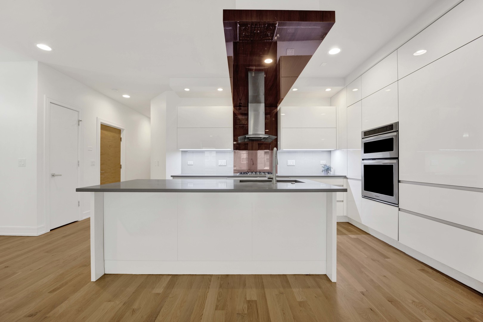 1014 North Larrabee Street, Unit 4N Chicago, IL 60610 - Photo 10 of 24 a large kitchen with stainless steel appliances a large counter top and a wooden floors