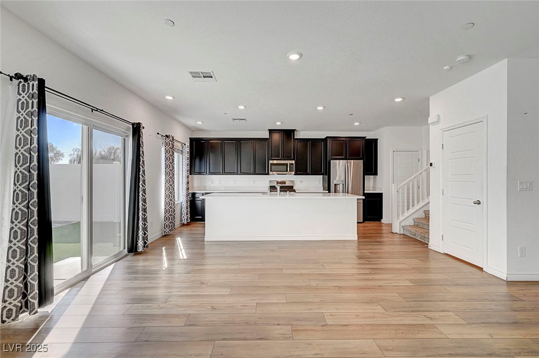 7204 North Decatur Boulevard North Las Vegas, NV 89084 - Photo 16 of 55 Kitchen featuring light countertops, light wood-style flooring, recessed lighting, and appliances with stainless steel finishes