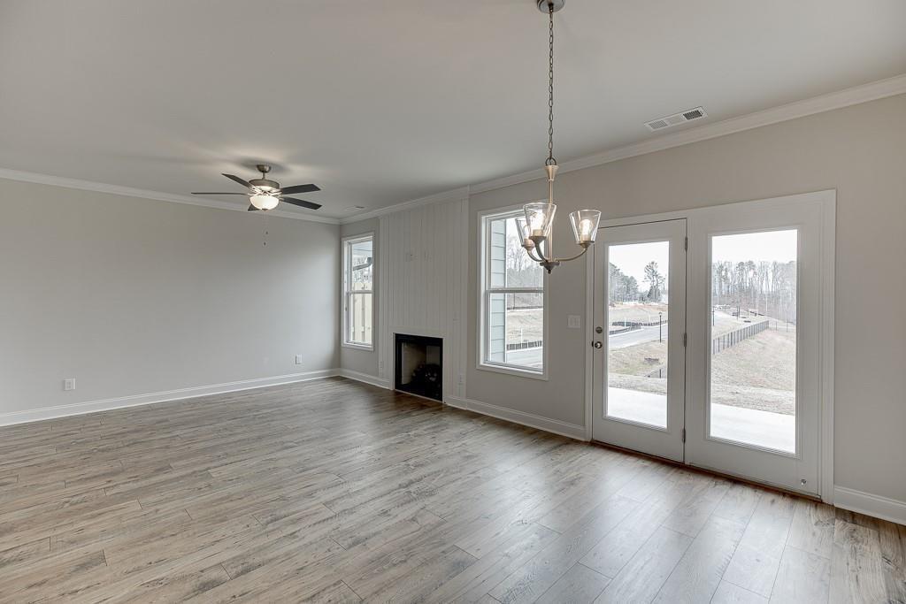 761 Woods Chapel Road Sugar Hill, GA 30518 - Photo 11 of 67 a view of an empty room with wooden floor and a window