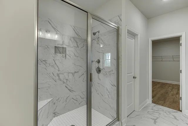 a backyard of a house with barbeque oven and brick wall