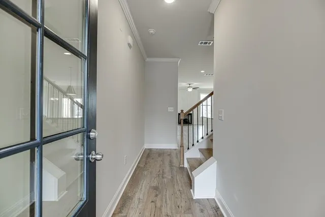 a kitchen with stainless steel appliances granite countertop a sink a stove and a wooden floors