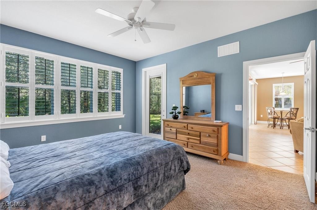 12905 New Market Street, Unit 102 Fort Myers, FL 33913 - Photo 13 of 30 a bedroom with a bed and a large window