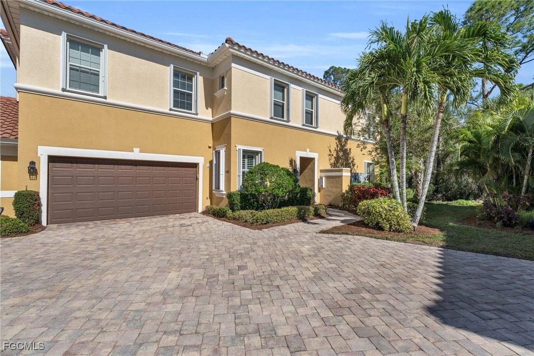 12905 New Market Street, Unit 102 Fort Myers, FL 33913 - Photo 2 of 30 a front view of a house with garden