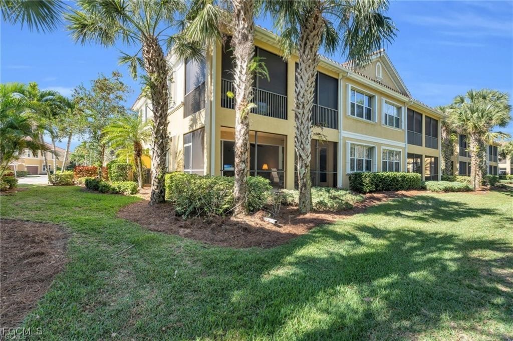 12905 New Market Street, Unit 102 Fort Myers, FL 33913 - Photo 25 of 30 a view of a building with a yard