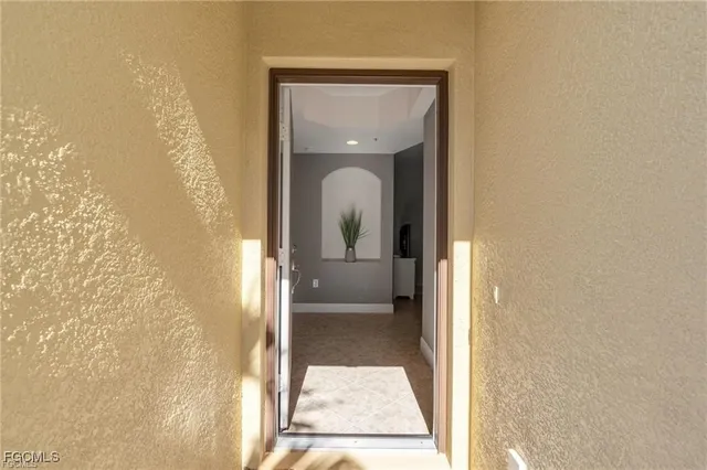 a view of a hallway with a glass door and a window