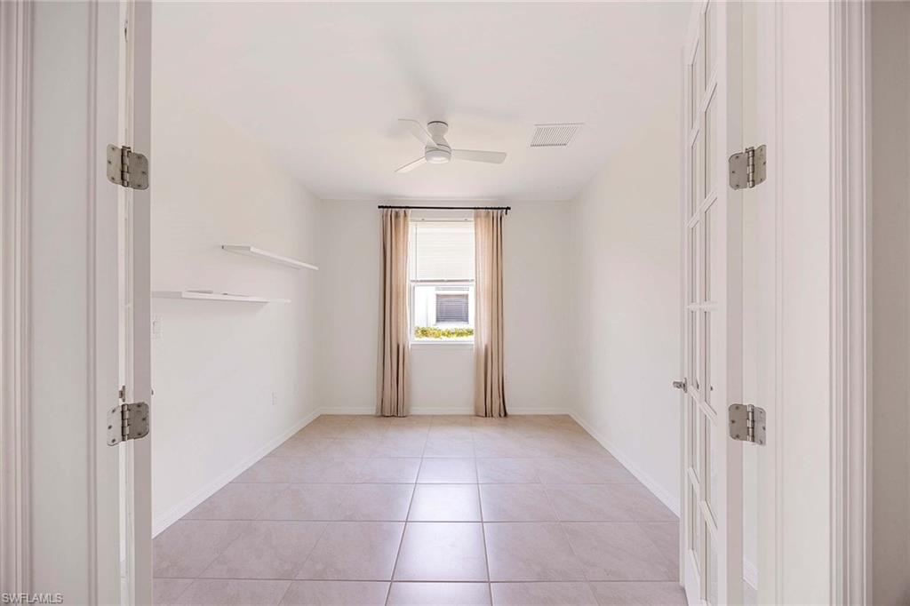 14799 Edgewater Circle Naples, FL 34114 - Photo 16 of 35 a view of an empty room with a window