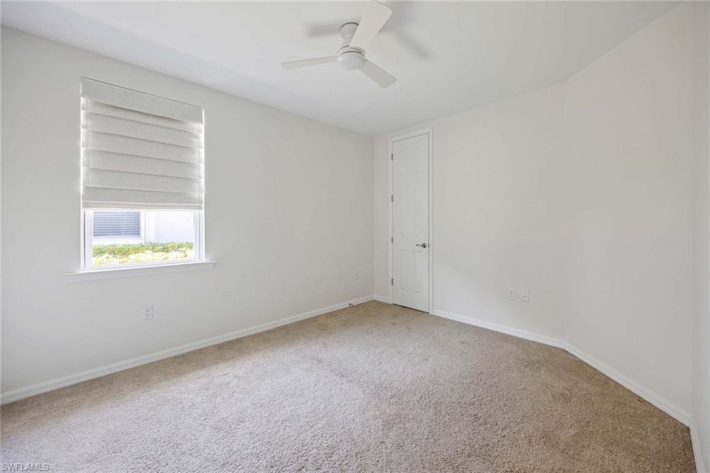 14799 Edgewater Circle Naples, FL 34114 - Photo 18 of 35 an empty room with a window and ceiling fan