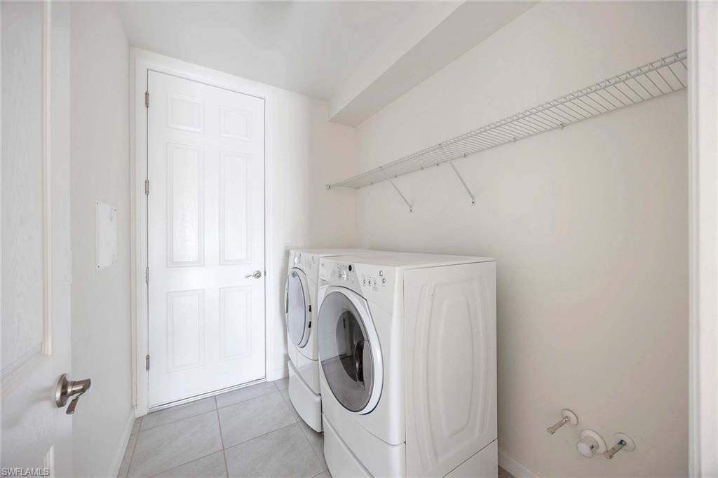14799 Edgewater Circle Naples, FL 34114 - Photo 20 of 35 a utility room with dryer and washer