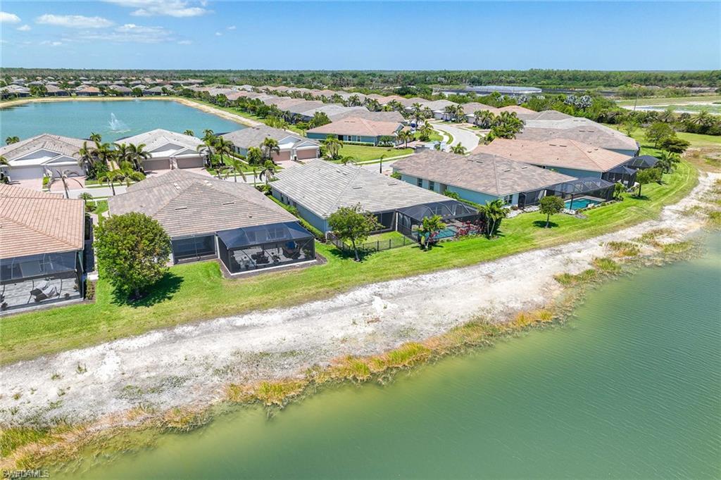 14799 Edgewater Circle Naples, FL 34114 - Photo 24 of 35 an aerial view of residential houses with outdoor space and ocean view